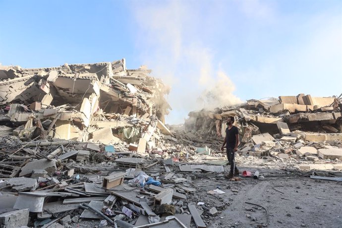 October 20, 2023, Gaza, Palestine: A Palestinian man inspects the damages after Israeli strikes on the  towers, of Al-Zahra City central Gaza Strip, amid the ongoing conflict between Israel and Palestinian Islamist group Hamas. The escalation and battles 