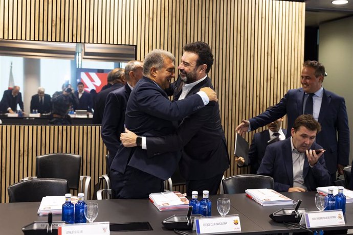 El presidente del FC Barceona, Joan Laporta, y el director general del Real Madrid, José Ángel Sánchez, se abrazan en una Asamblea de LaLiga.