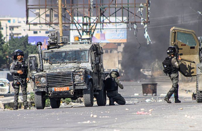 October 13, 2023, Nablus, West bank, Palestine: Israeli soldiers fire bullets and tear gas at Palestinian protesters to suppress them, during a demonstration in support of Gaza, which has been under Israeli air strikes since October 7, near the Hawwara 