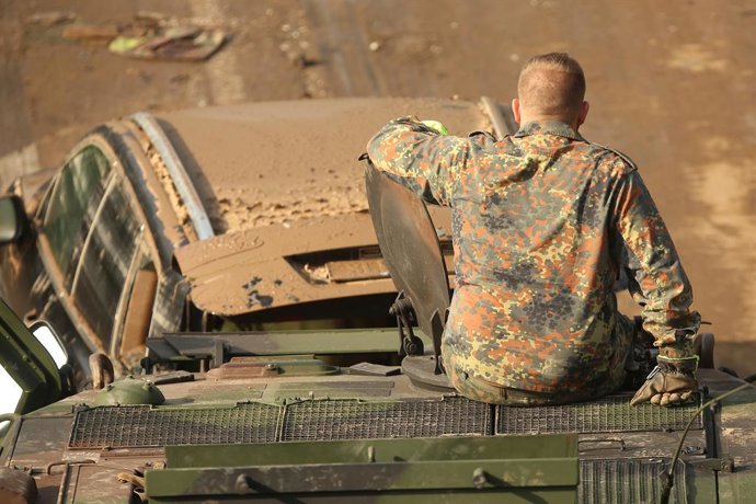 Archivo - 18 July 2021, North Rhine-Westphalia, Erftstadt: A soldier of the Bundeswehr sits on his tank on the B265 near Erftstadt Liblar while the tank tows a destroyed car. Photo: David Young/dpa