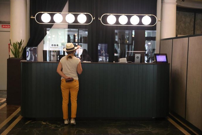 Archivo - Una mujer espera en el vestíbulo de un hotel.