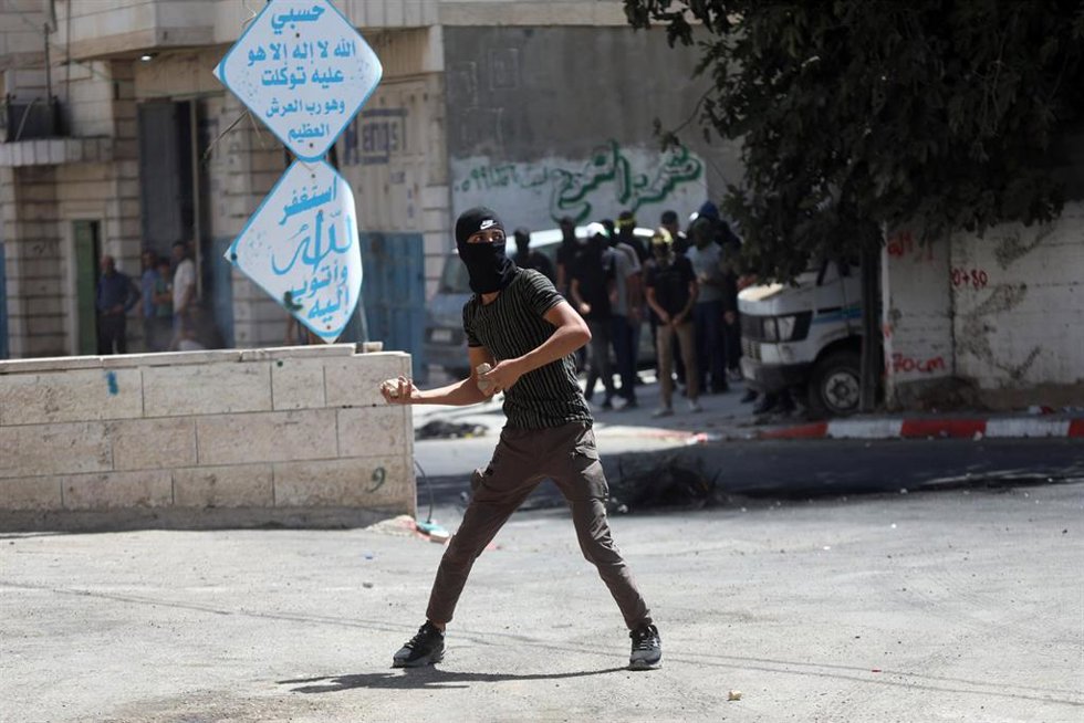 Archivo - Manifestantes palestinos tiran piedras al Ejército israelí en Hebrón, Cisjordania
