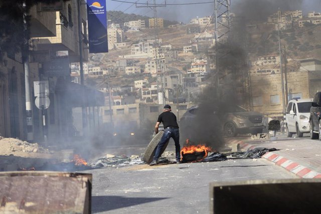 October 31, 2023, Tubas, West bank, Palestine: A Palestinian seen burning tires to obstruct the passage of Israeli forces storming the city of Tubas in the northern West Bank.