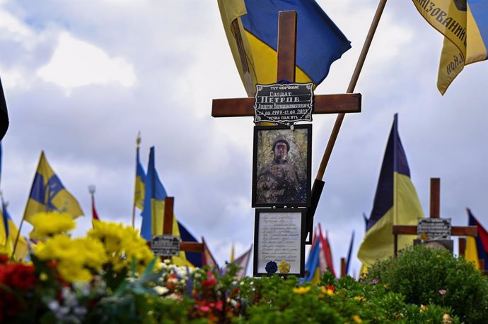 October 28, 2023, Lviv, Ukraine: LVIV, UKRAINE - OCTOBER 28, 2023 - The photograph of a perished Ukrainian soldier is seen on the cross at the grave in the field of honorary burials at the Lychakiv Cemetery, Lviv, western Ukraine.