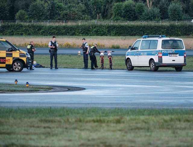 Archivo - July 13, 2023, Hamburg, Hamburg, Germany: 10 activists of the Last Generation entered the Hamburg Airport on July 13, 2023 prior to the beginning of the air traffic. Some of them rode a bike and others glue themselves on the taxyway road. With t