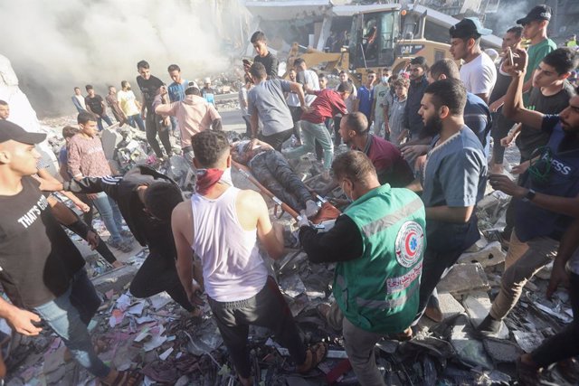 Trabajadores de los equipos de rescate palestino evacuan a una víctima de uno de los bombardeos del Ejército de Israel contra la Franja de Gaza