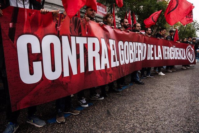 Varias personas protestan con una pancarta durante una manifestación contra la amnistía, frente a la sede del PSOE, a 11 de noviembre de 2023, en Madrid (España). 