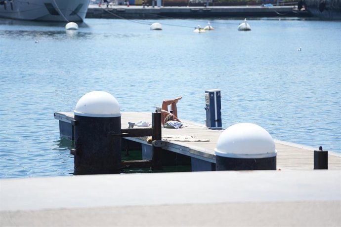 Archivo - Una persona toma el sol (archivo)