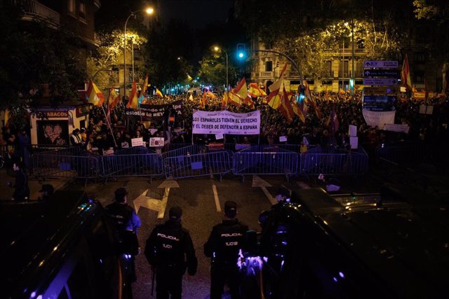 Decenas de personas portan carteles y pancartas frente a la Policía, durante una protesta en la calle Ferraz