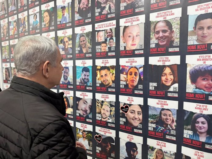 HANDOUT - 14 November 2023, Israel, Galilee: Israel's Prime Minister Benjamin Netanyahu stands in front of backdrop of photos of the hostages taken by Palestinian militants group Hamas during a meeting with Northern Confrontation Line Council Heads at t