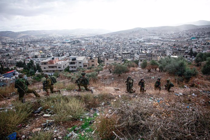 November 19, 2023, Nablus, West Bank, Palestine: Israeli soldiers take their positions during a military operation in the Balata refugee camp, West Bank.