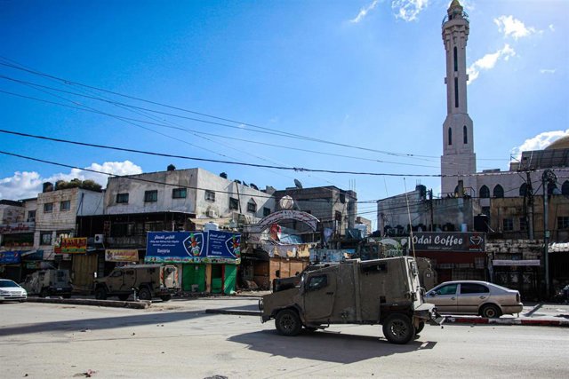 Vehículos militares israelíes cierran la entrada al campo de refugiados de Balata durante una redada para arrestar a palestinos, al este de Nablús, en el norte de Cisjordania