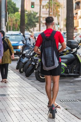 Archivo - Una persona circula en un patinete eléctrico por la acera.