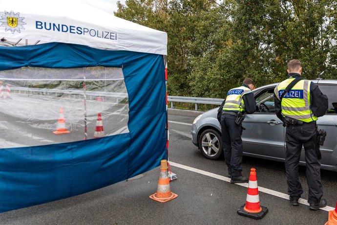24 October 2023, Brandenburg, Bademeusel: Federal police officers talk to the driver of a car on the A15 highway, on the border between Poland and Germany. Temporary stationary internal border controls for the borders with Poland, the Czech Republic and