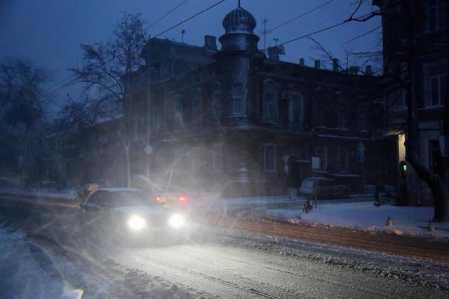 November 26, 2023, Odessa, Ukraine: A car shines its headlights on a strong snowstorm on Sofievskaya Street. Odessa weather forecasters believe that the current snowfall has become the heaviest in the last five years and has surpassed the scale of the bli