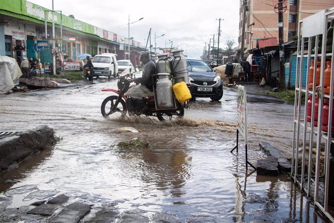 November 25, 2023, Nakuru, Kenya: A boda boda carrying milk churns rides past a flooded section of a road amid increased rainfall attributed to the El-Nino phenomenon.