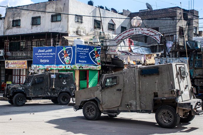 November 21, 2023, Nablus, Palestine: Israeli military vehicles close the entrance to Balata refugee camp during a raid to arrest wanted Palestinians, east of Nablus, in the northern West Bank.