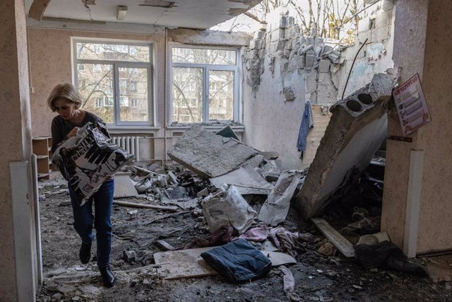 November 25, 2023, Kyiv, Ukraine: A worker carries books and toys from a kindergarten building destroyed by a Russian drone in Kyiv.
