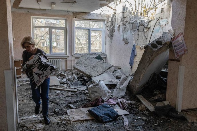 November 25, 2023, Kyiv, Ukraine: A worker carries books and toys from a kindergarten building destroyed by a Russian drone in Kyiv.