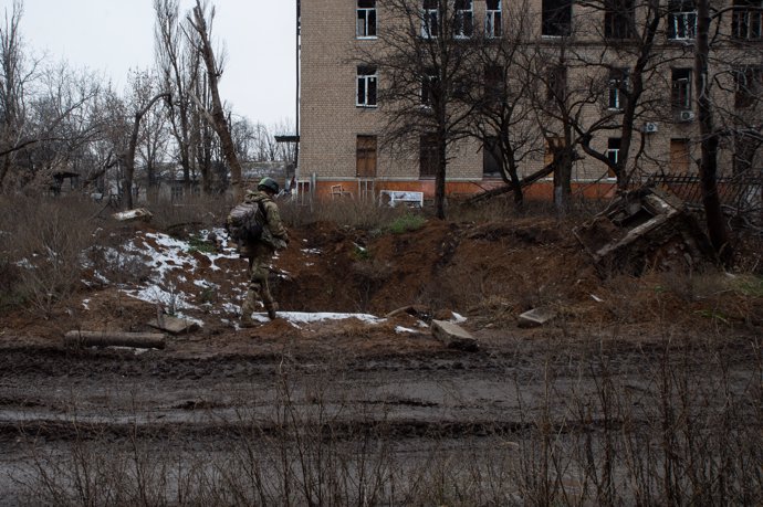 A large crater sits in front of the remains of an apartment building in Chasiv Yar. The city of Chasiv Yar continues to come under heavy fire from Russian positions outside the city.,
