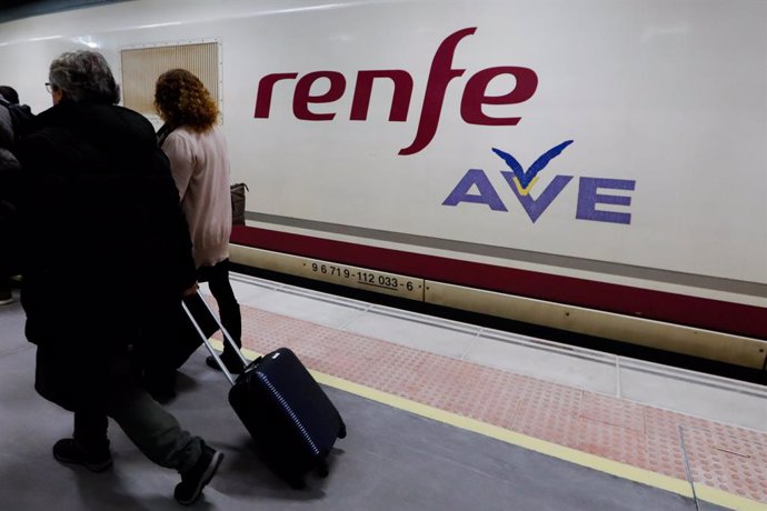 Archivo - Arxiu - Dos passatgers passen per davant del primer tren comercial d'alta velocitat des de Múrcia a Madrid.
