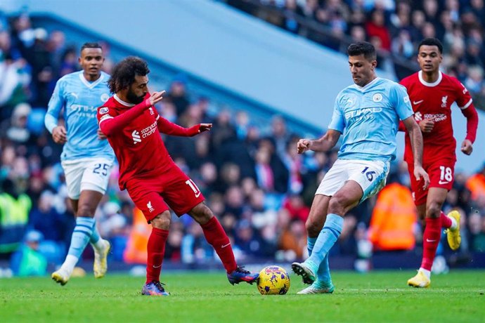 Liverpool forward Mohamed Salah (11) takes on Manchester City midfielder Rodri (16) during the English championship Premier League football match between Manchester City and Liverpool on 25 November 2023 at the Etihad Stadium in Manchester