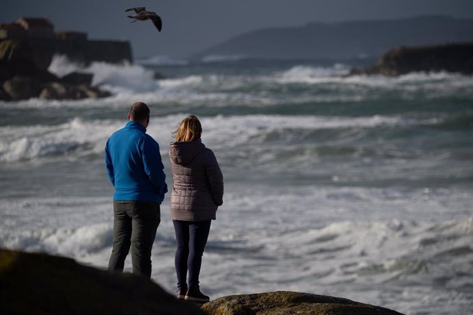 Dos personas observan el mar con olas por el temporal, en la playa de A Lanzada, a 5 de noviembre de 2023, en O Grove, Pontevedra, Galicia (España). 