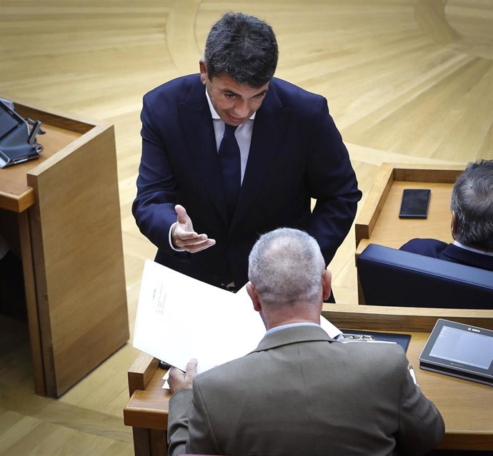 El president, Carlos Mazón, entrega unas carpetas al síndic de Compromís, Joan Baldoví