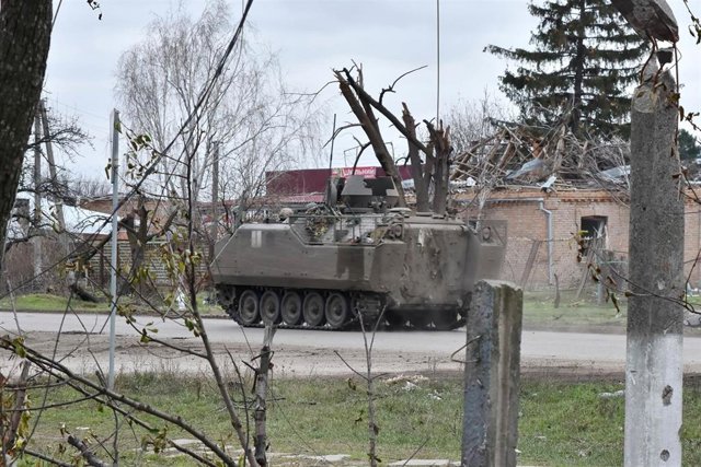December 6, 2023, Orikhiv, Ukraine: An armored Ukrainian military vehicle seen passing on the road along the private houses destroyed by Russian shelling in Orikhiv. Ukrainian President Volodymyr Zelenskyy said that he had ordered an expansion of defensiv