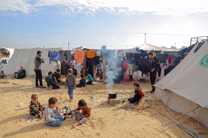 GAZA, Dec. 8, 2023  -- Children are seen at a temporary shelter in the southern Gaza Strip city of Rafah, Dec. 8, 2023. An estimated 1.9 million people are displaced in Gaza (about 85 percent of the population), lacking necessities such as food, water, 