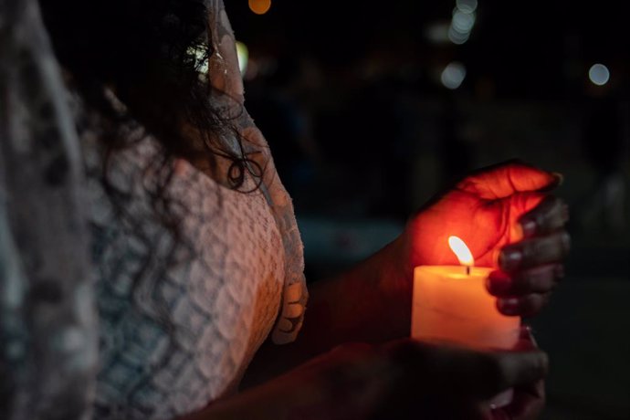 Archivo - May 31, 2021, Medellin, Antioquia, Colombia: A group of demonstrators, partially nude with white clothes and candles perform a protest against police brutality and unrest that has caused at least 70 deaths during the first month of Anti-govern