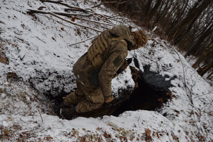 December 9, 2023, Kyiv, Kharkiv Oblast, Ukraine: A Ukrainian soldiers walks into a trench near an artillery position. As the war continues into its second winter, Ukrainian soldiers complain of ammunition shortage across the frontlines.