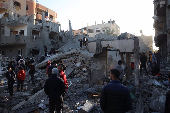 MAGHAZI REFUGEE CAMP, Dec. 11, 2023  -- People inspect the damage after an Israeli airstrike in Maghazi refugee camp, central Gaza Strip, on Dec. 11, 2023. The Ministry of Health in Gaza announced on Monday that the Palestinian death toll in the Gaza St