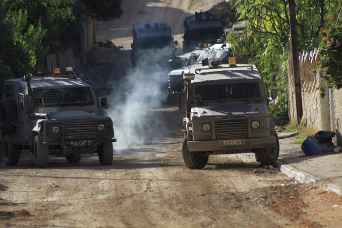 November 29, 2023, Jenin, West Bank, Palestinian Territory: Armored military vehicles enter the Jenin refugee camp as Israeli forces raid into refugee camp in Jenin, West Bank, on November 29, 2023