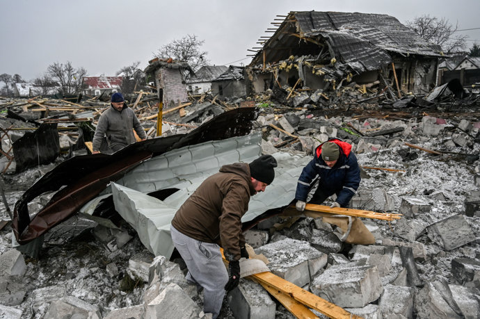 11 December 2023, Ukraine, Kiev: Men disassemble the rubble of a destroyed house that was damaged as a result of the explosion of a missile attack by the Russian army in Kyiv. Photo: Sergei Chuzavkov/SOPA Images via ZUMA Press Wire/dpa