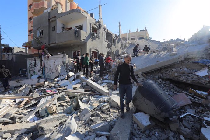 December 11, 2023, Al-Maghazi, Gaza Strip, Palestinian Territory: Palestinian residents conduct a search and rescue operation among the destroyed buildings after Israeli attacks in Al-Maghazi, Gaza.
