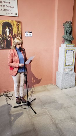 La historiadora Mercedes Sanz lee parte del documento histórico que describe la proclamación de Isabel I de Castilla, ante el busto de La reina