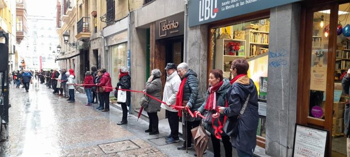 Cadena humana desde el Mercado de La Ribera hasta la librería Libu para visibilizar a las personas en riesgo de exclusión social .
