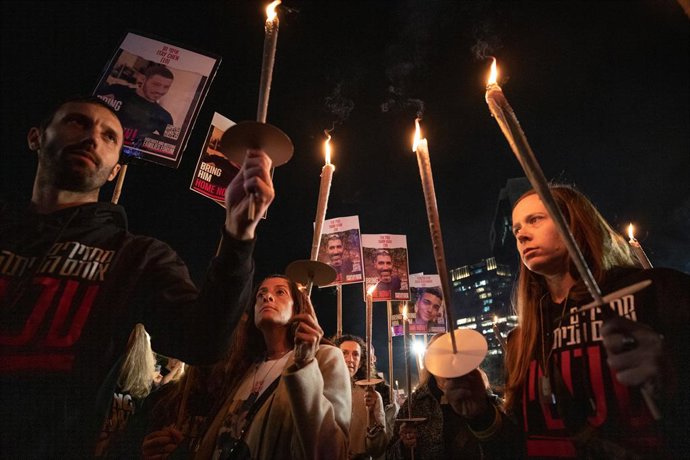 TEL AVIV, Dec. 8, 2023  -- People carry lit candles during a rally calling for the release of hostages held in Gaza, in Tel Aviv, Israel, Dec. 7, 2023.