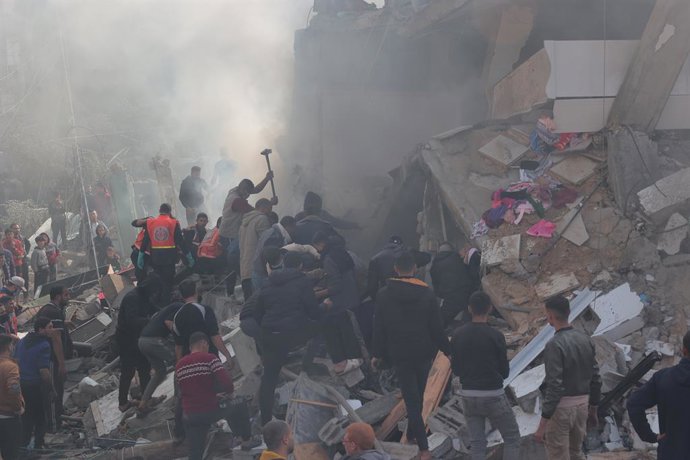 December 14, 2023, Rafah, Gaza Strip, Palestinian Territory: Rescuers and civilians look for survivors amid the rubble of destroyed buildings following Israeli bombardment in Rafah, in the southern Gaza Strip on December 14, 2023, Thousands of Palestini
