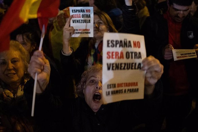 Archivo - Manifestantes sostienen carteles, durante la concentración en contra de la amnistía, en la sede del PSOE en la calle Ferraz, a 8 de noviembre de 2023