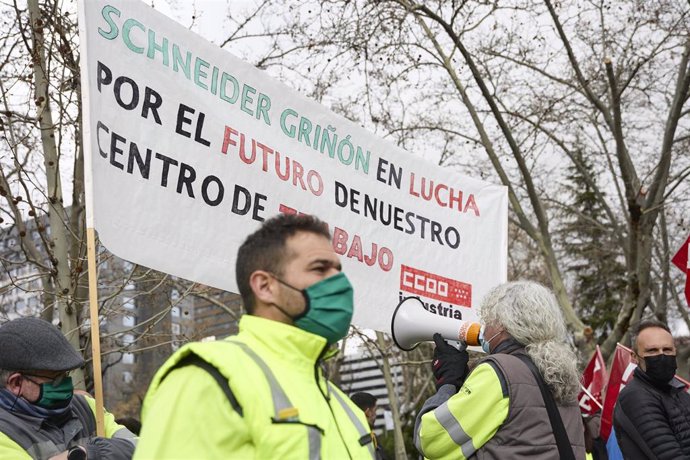 Archivo - Varias personas con una pancarta para defender el futuro de Schneider, durante una concentración de CCOO contra el traslado de Schneider Electric a Italia, frente al Ministerio de Industria, a 7 de marzo de 2022, en Madrid (España). La protest