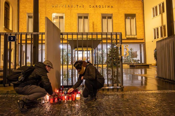 December 21, 2023, Prague, Czech Republic: People light candles in front of Charles University main building following the shooting at one of it's buildings in Prague. According to the Czech police, 14 people were killed and 25 people were injured, but 