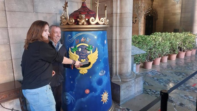 La representante de la Plataforma por el Transporte Público, Margarita De Noia, y de la Federación de la Asociaciones de Vecinos de Palma, Rfel Garcia, entregan la carta a los Reyes Magos.