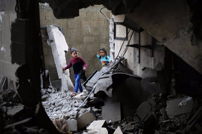 RAFAH, Dec. 14, 2023  -- Children are seen amid the rubble of a building after an Israeli airstrike in the southern Gaza Strip city of Rafah, on Dec. 14, 2023. At least 111 Palestinians were killed and dozens of others wounded in Israeli attacks on the Ga