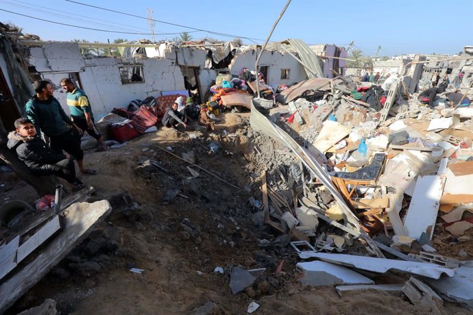 December 22, 2023, Dair El-Balah, Gaza Strip, Palestinian Territory: Palestinians inspect the damage to a residential buildings belonging following Israeli bombardment on Dair El-Balah central of Gaza Strip, on December 22, 2023