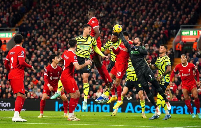 23 December 2023, United Kingdom, Liverpool: Liverpool goalkeeper Alisson Becker punches the ball away from danger during the English Premier League soccer match between Liverpool and Arsenal at Anfield. Photo: Peter Byrne/PA Wire/dpa