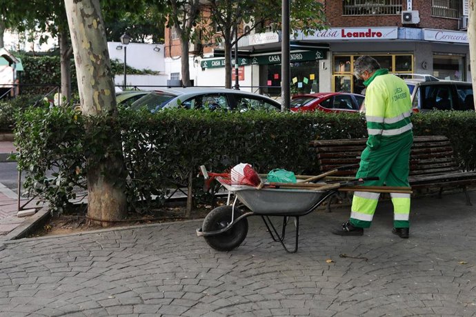 Archivo - Un trabajador del servicio de limpieza con una carretilla trabaja en una calle de Madrid.