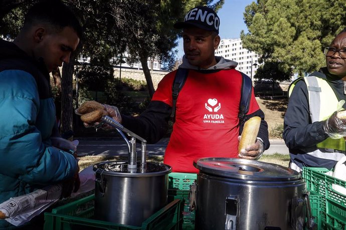 Imagen de archivo de un voluntario de la Fundación Ayuda a una Familia durante un reparto de alimentos a personas sin recursos en el viejo cauce del Túria.  