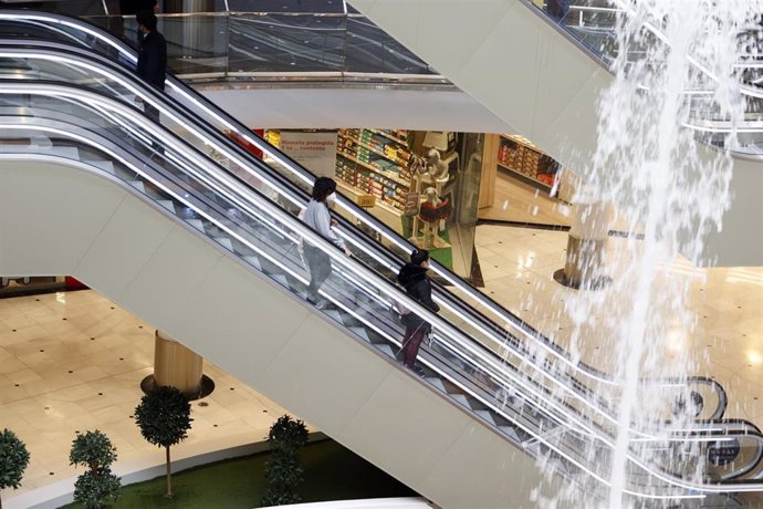 Archivo - Varias personas, en una escalera mecánica, en un centro comercial de Valladolid, Castilla y León (España). 